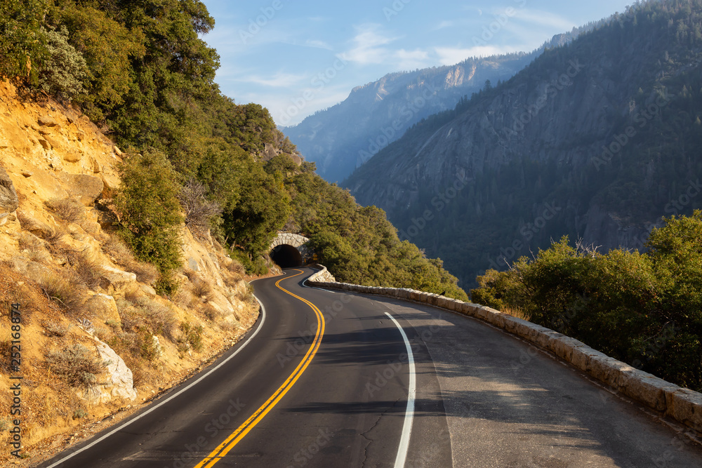 Fototapeta premium View of a scenic road in the Valley surrounded by mountains. Taken in Yosemite National Park, California, United States.