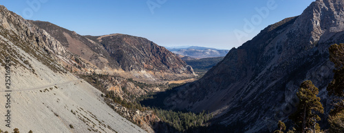 Panoramic view of a scenic road, Tioga Pass, in the Valley surrounded by mountains. Taken near Lee Vining, California, United States.