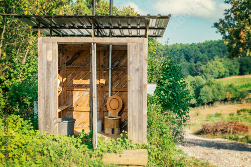 Tableau sur toile Wooden shed ecological composting toilet on countryside eco farm - Concept image