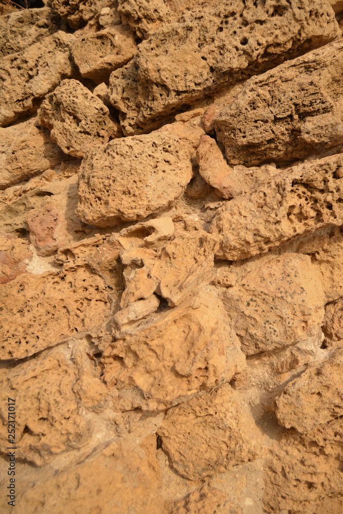 Weathered sandstone block wall. Abstract background