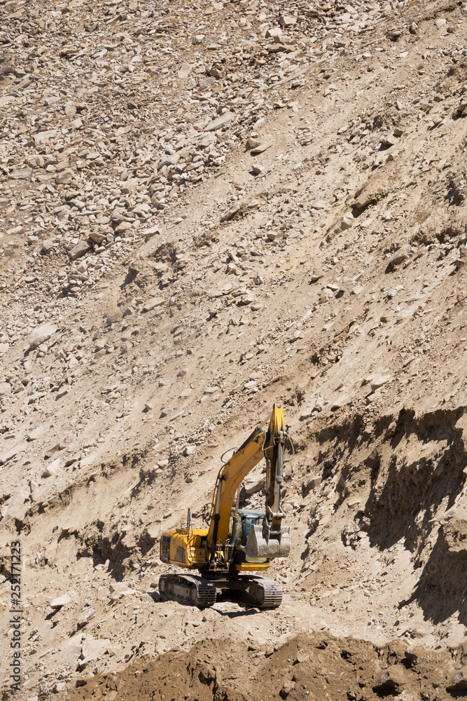 Excavator or large backhoe be under construction a road Excavator or large backhoe be under construction a road