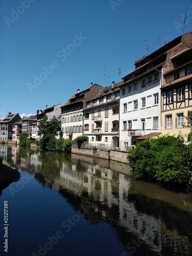 River view sunny day in Strasbourg with relections of houses