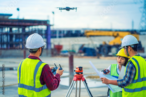 civil engineering flying drone over construction site survey for land and building project.