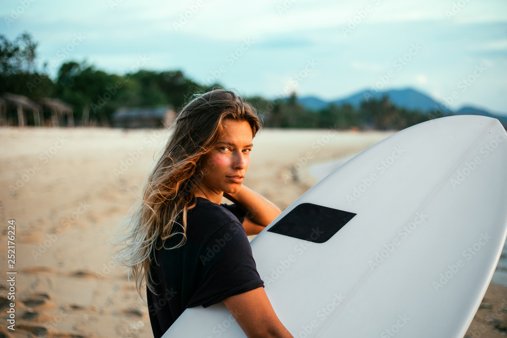 Surfer girl on beach