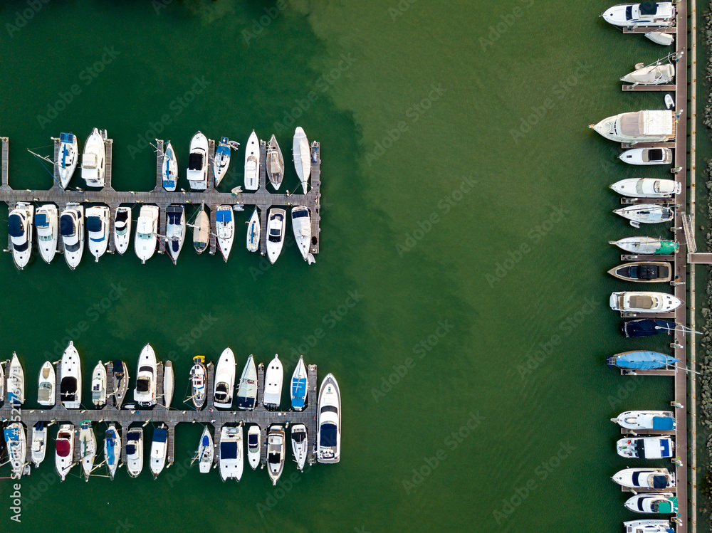 Aerial view of anchored luxury yacht and catamaran in marina (Photo from drone)