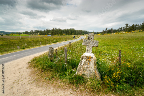 A stone cross on the side of the road on the way to santiago de Compostela photo