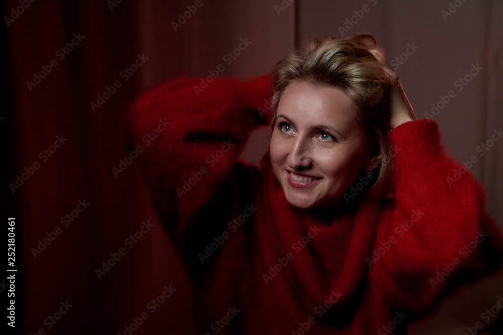 Portrait of a middle-aged woman in the room. Photography in the Studio. Photo shoot in a dark key Portrait of a middle-aged woman in the room. Photography in the Studio. Photo shoot in a dark key