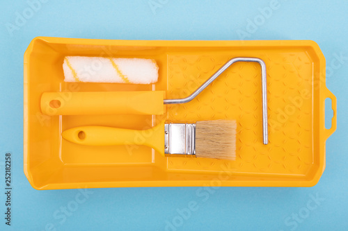 Paint tools. Paint brush and roller with tray for paint. Mock-up