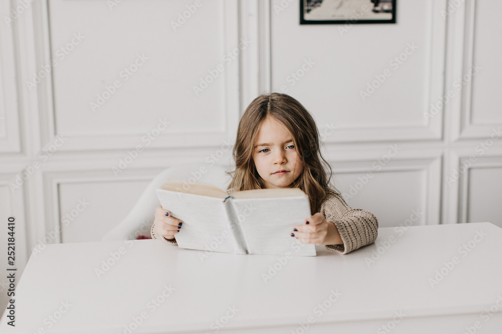 little beautiful girl doing homework: reading a book little beautiful girl doing homework: reading a book