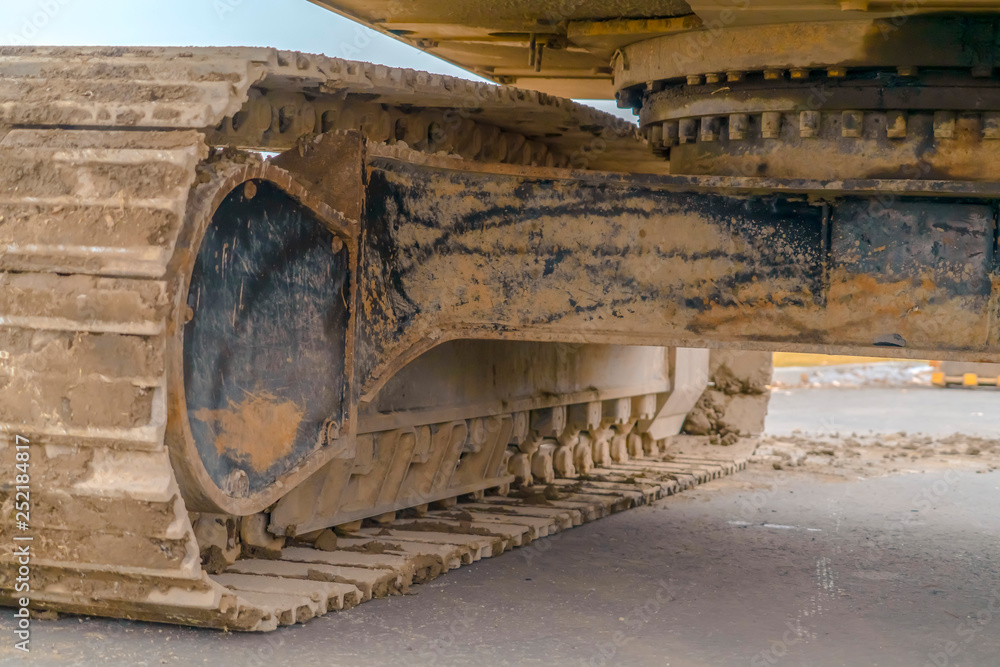 Excavator with caked mud on the grouser pad Excavator with caked mud on the grouser pad