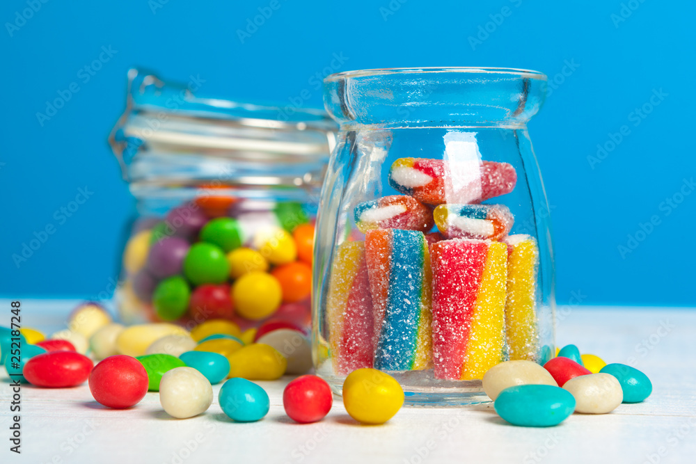Bottles with sweet candies on table Bottles with sweet candies on table