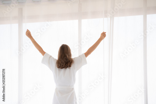 pregnancy, motherhood, people and expectation concept - close up of happy pregnant woman opening window curtains.