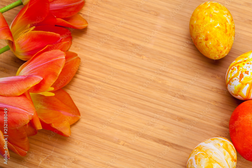 Easter eggs with tulips on wooden board, easter holiday concept. Copyspace for text Easter eggs with tulips on wooden board, easter holiday concept. Copyspace for text