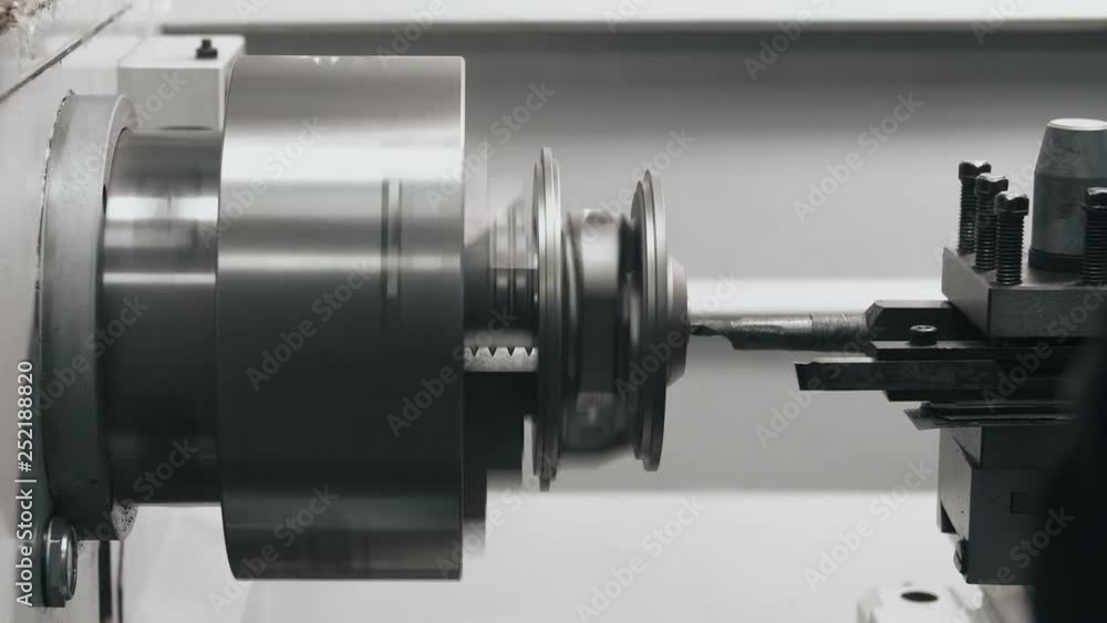 Turning lathe machine with cutting tool in process, old metal auto part restoration on milling machine in repair shop Turning lathe machine with cutting tool in process, old metal auto part restoration on milling machine in repair shop