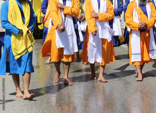 barefoot Sikh religion men during the parade in the city