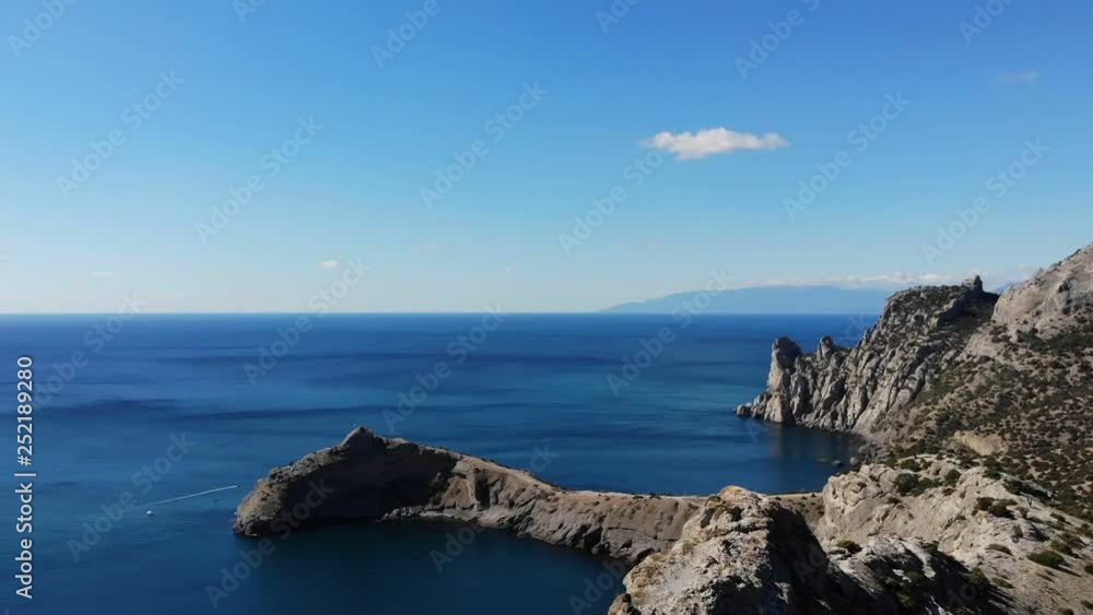 bird eye view brave tourists climb up to rocky mountain top against wonderful boundless sea and amazing blue sky bird eye view brave tourists climb up to rocky mountain top against wonderful boundless sea and amazing blue sky