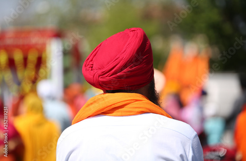 man with red turban and white shirt