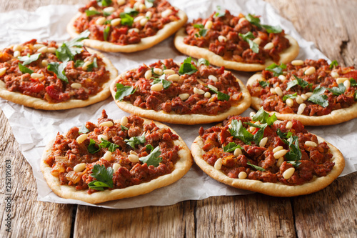 Tasty Lebanese pizza Sfiha with minced meat, tomatoes, onions, spices and pine nuts closeup. horizontal photo