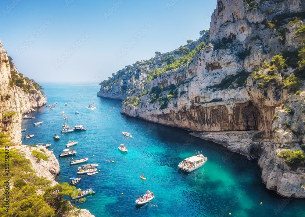 Yachts at the sea in France. Aerial view of luxury floating boat on transparent turquoise water at sunny day. Summer seascape from air. Top view from drone.  Travel concept and idea