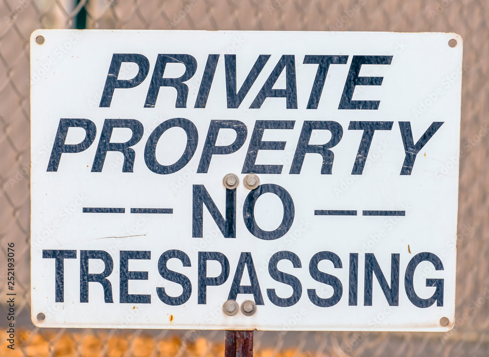 Private Property No Trespassing sign on a fence