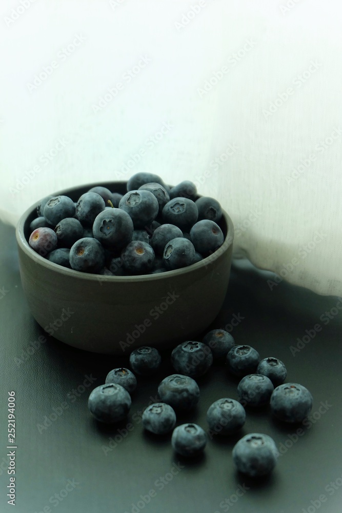 Blueberries on black plate and black background. Blueberries on black plate and black background.
