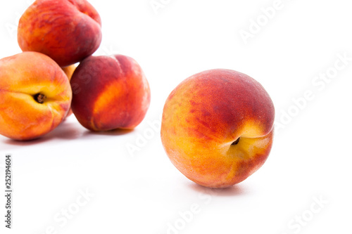 Group of ripe peach fruit isolated on white background.