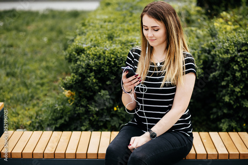 Handsome smiling woman with mobile phone