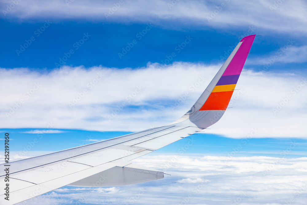 Aircraft Wing on blue sky and white clouds background. Aircraft Wing on blue sky and white clouds background.