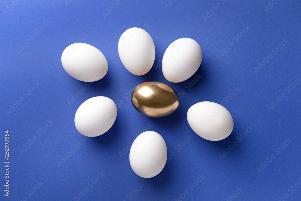 Golden egg among white ones on color background. Concept of uniqueness Golden egg among white ones on color background. Concept of uniqueness