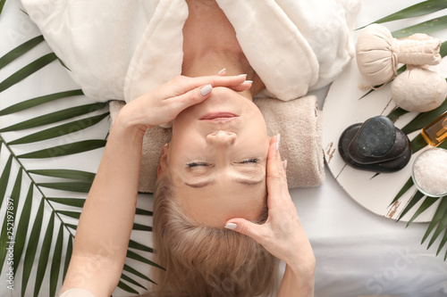 Mature woman receiving face...