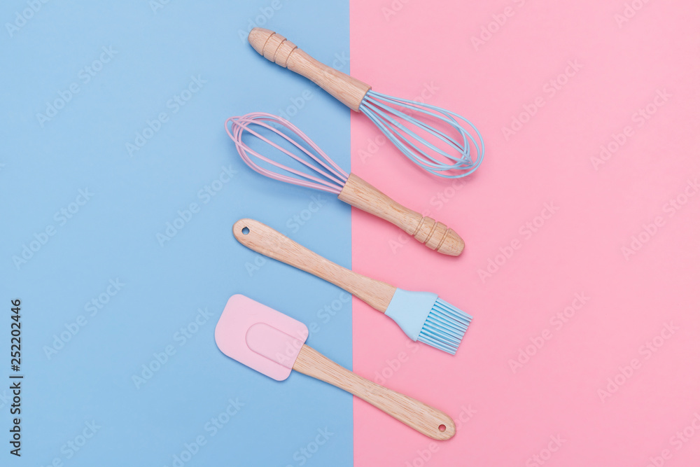 pastel colored whisk, spatula, and pastry brush on a pastel pink and blue background. Minimal style. pastel colored whisk, spatula, and pastry brush on a pastel pink and blue background. Minimal style.