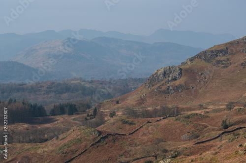 The Great Langdale skyline of Crinkle Crags, Bowfell and the Langdale Pikes seen above Lingmoor Fell from the lower slopes of Loughrigg Fell, Lake District, UK © Nigel