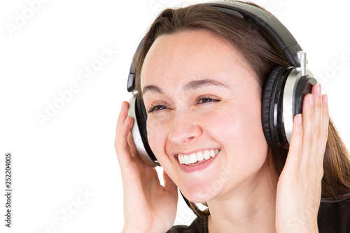 Cheerful pretty caucasian teenage girl with headphones eyes closed