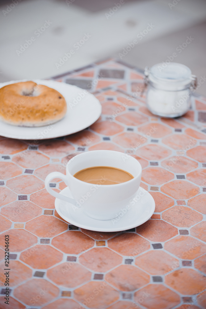 cup of coffee with bread on table in the morning with sunlight, breakfast cup of coffee with bread on table in the morning with sunlight, breakfast