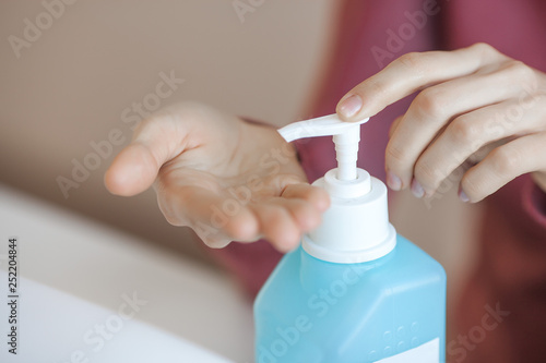 Woman desinfecting her hands before manicure procedure. Master preparing place for client. Hand care.