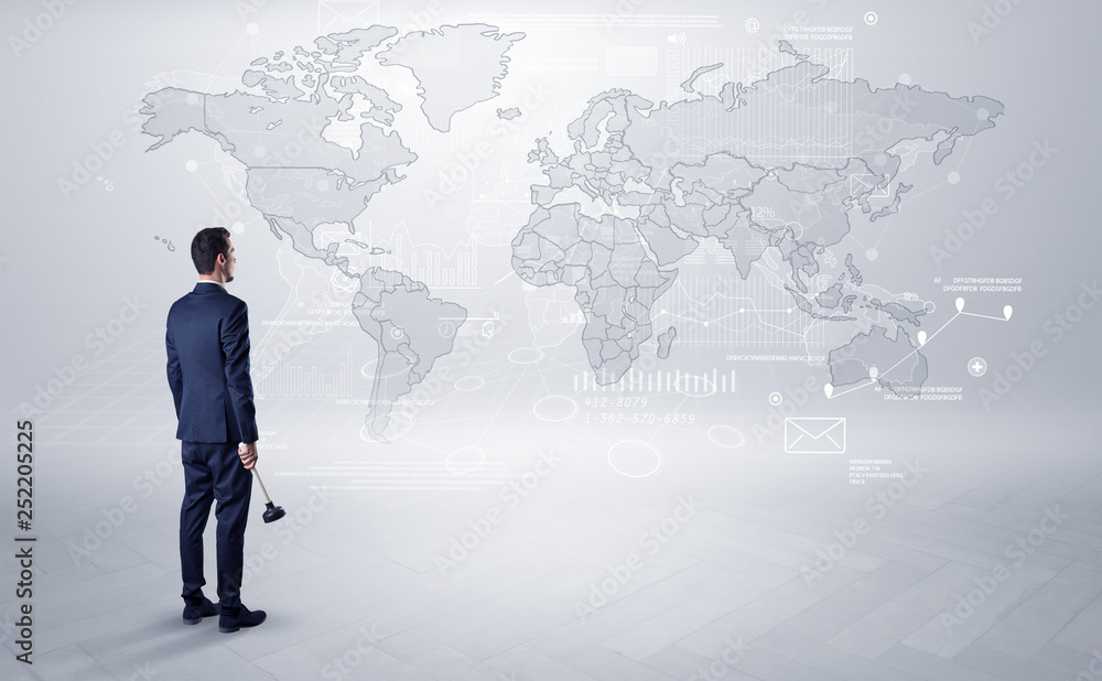 Businessman standing with his back and looking at a worldwide map with objects in his hand
Businessman standing with his back and looking at a worldwide map with objects in his hand