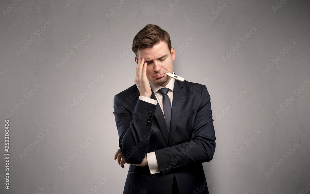 Young tired businessman with thermometer and copy space
Young tired businessman with thermometer and copy space