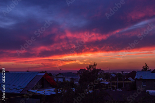 Colorful Summer Sunset over Houses