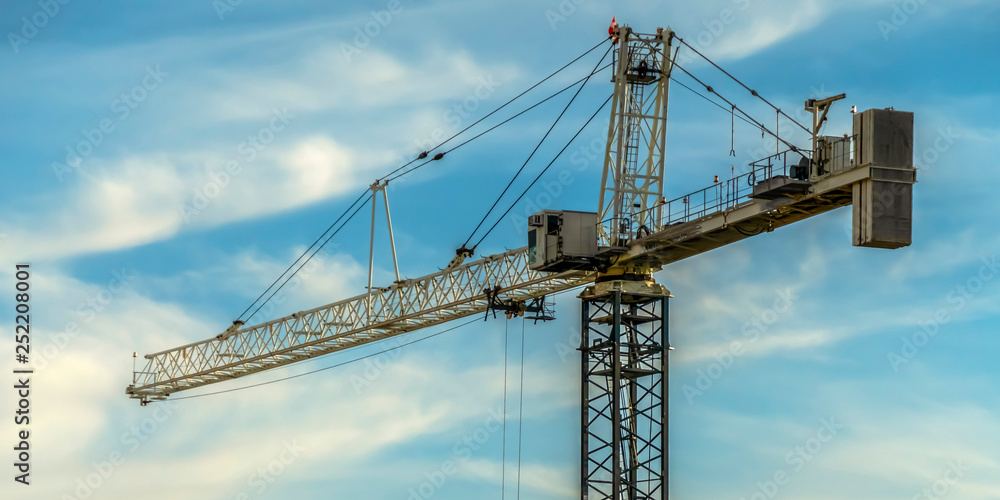 Tower crane with cloudy blue sky background Tower crane with cloudy blue sky background