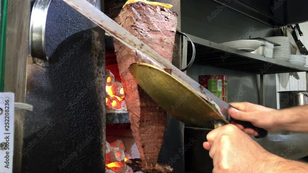 cutting Turkish doner kebab, kebab roll, sandwich, traditional turkish