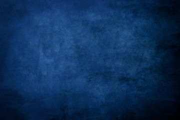 Dark blue grungy distressed canvas bacground