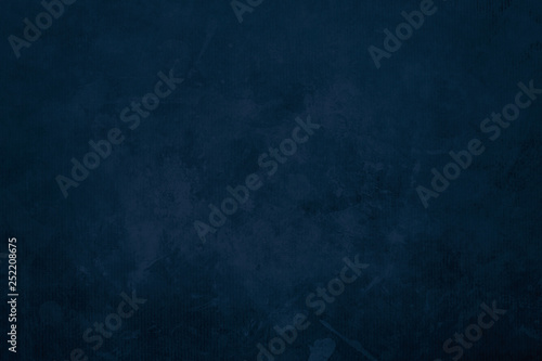 Dark blue grungy canvas background or texture