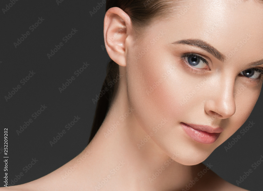 Beauty woman face hair skin healthy closeup over gray background Beauty woman face hair skin healthy closeup over gray background