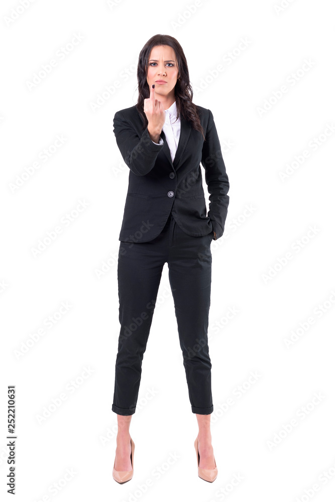 Frustrated annoyed business female employee showing middle finger gesture at camera. Full body isolated on white background. Frustrated annoyed business female employee showing middle finger gesture at camera. Full body isolated on white background.