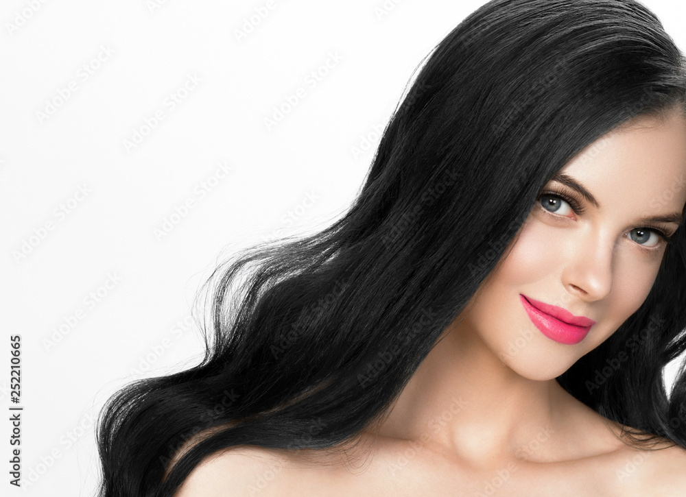 Fototapeta premium Brunette woman with long black hair and pink lipstick lips, female with beautiful eyes with lash extensions 