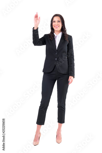 Friendly smiling happy business woman in elegant suit meeting and greeting with waving hand. Full body isolated on white background. 