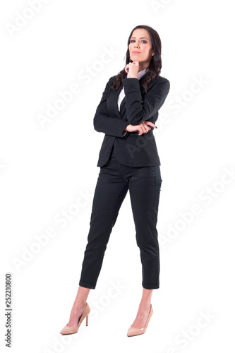 Elegant beautiful caucasian business woman in suit posing with finger under chin. Full body isolated on white background. 