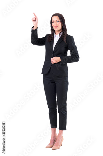 Young happy beautiful elegant business woman in formal suit pointing finger up. Full body isolated on white background. 