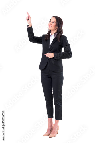 Friendly smiling business woman pointing finger using touch screen on virtual reality. Full body isolated on white background. 