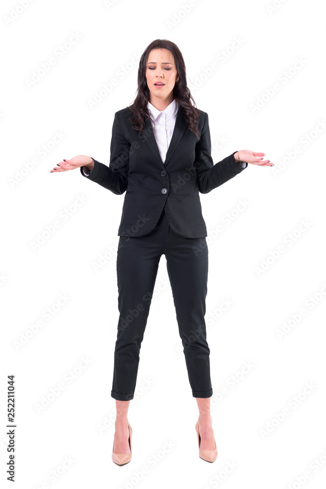 Confused upset business woman shrugging with arms raised and closed eyes. Full body isolated on white background. Confused upset business woman shrugging with arms raised and closed eyes. Full body isolated on white background.